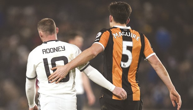 Manchester Unitedu2019s English striker Wayne Rooney (L) greets Hull Cityu2019s English defender Harry Maguire after the EFL (English Football League) Cup semi-final second-leg football match at the KCOM Stadium in Kingston upon Hull, north east England on Thursday.