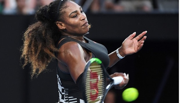Serena Williams of the US hits a return against Venus Williams of the US during the women's singles final on day 13 of the Australian Open tennis tournament in Melbourne.