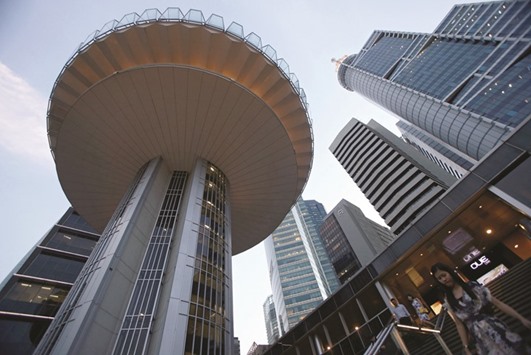 People pass the skyline of the central business district of Singapore. Home prices in the city-state have declined by about 11% since 2013 and sales have dropped to around half of that yearu2019s level, according to data released by the Urban Redevelopment Authority.