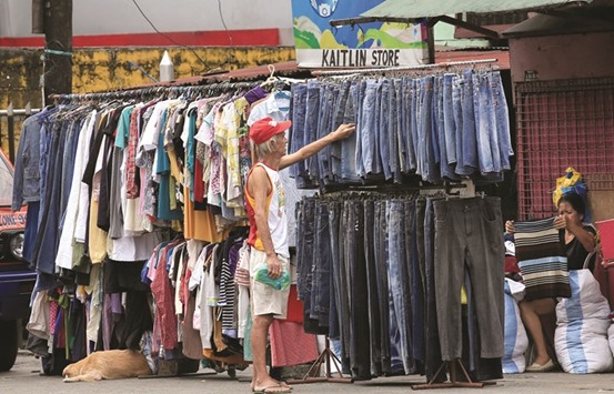 Passersby look at used clothing for sale at an ambulant thrift shop along a street in metro Manila. With the World Bank forecasting expansion of more than 6% for eight years until 2019, unparalleled in the nationu2019s history, the Philippines is mimicking gains seen in Malaysia and Thailand in the 1990s as they industrialised. Growth in the Philippines was 6.8% in 2016, faster than Chinau2019s, data released on Thursday showed.