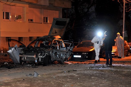 Police officers investigate a crime scene in Podgorica on January 19. Heavily-armed police are guarding the streets of Montenegrou2019s capital after a spike in gangland violence rattled the Balkan country.