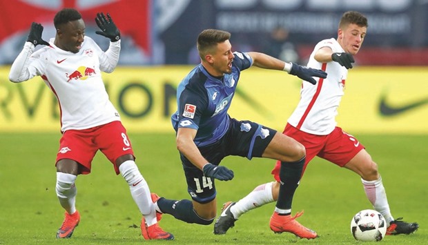 RB Leipzigu2019s Naby Deco Keita (left) and Diego Demme (right) attempt to stop Hoffenheimu2019s Sandro Wagner from scoring yesterday. (Reuters)
