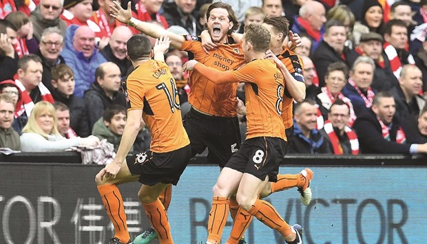 Wolverhampton Wanderersu2019 Richard Stearman (centre) celebrates with teammates after scoring a goal against Liverpool during the English FA Cup fourth round match at Anfield in Liverpool, north west England, yesterday. (AFP)