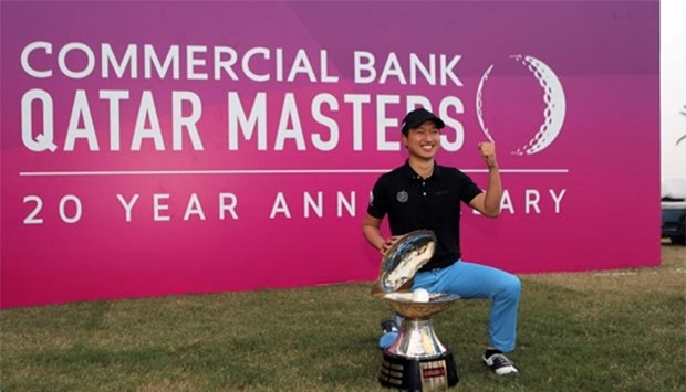 South Korea's Wang Jeung-Hun poses with the trophy upon winning the Qatar Masters tournament at the Doha Golf Club in Doha on Sunday.