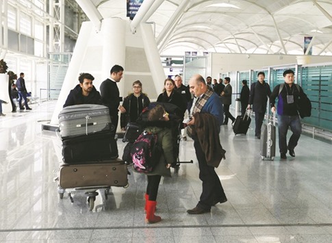 Fuad Sharef Suleman and his family push their belongings after returning to Iraq from Egypt, where they were prevented from boarding a plane to the US, following US President Donald Trumpu2019s decision to temporarily bar travellers from seven countries, including Iraq, at Erbil International Airport, Iraq ,yesterday. A growing number of technology executives have voiced concerns over new US immigration restrictions that could interfere with how they do business.