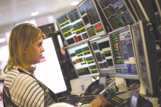A trader studies information on trading screens at ETX Capital in central London. Recent history suggests it doesnu2019t pay to expect the worst every time a political shock hits markets.