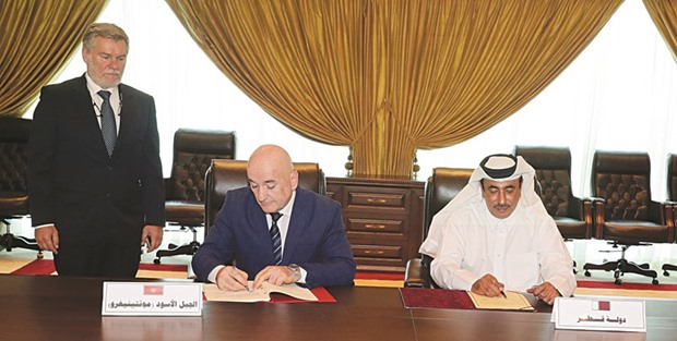 HE al-Sulaiti and Nurkovi? sign the agreement during a ceremony held at the MoTC headquarters in Doha.