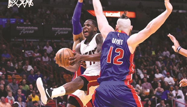 Miami Heat guard Dion Waiters (center) drives between Detroit Pistons forward Tobias Harris (left) and center Aron Baynes (right) during the second half at American Airlines Arena. The Heat won 116-103. PICTURE: USA TODAY Sports
