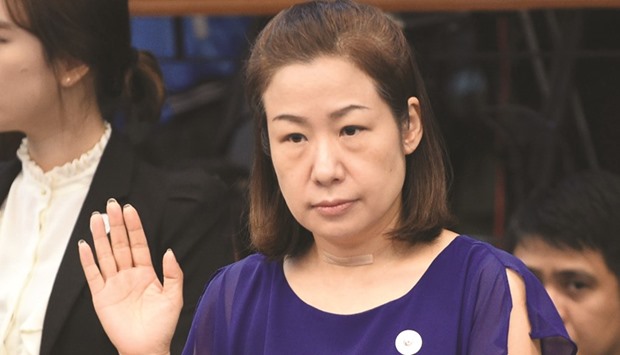Choi Kyung-jin, wife of late South Korean businessman Jee Ick-Joo, who was murdered  allegedly by suspected policemen, taking her oath at the start of Senate hearing in Manila.
