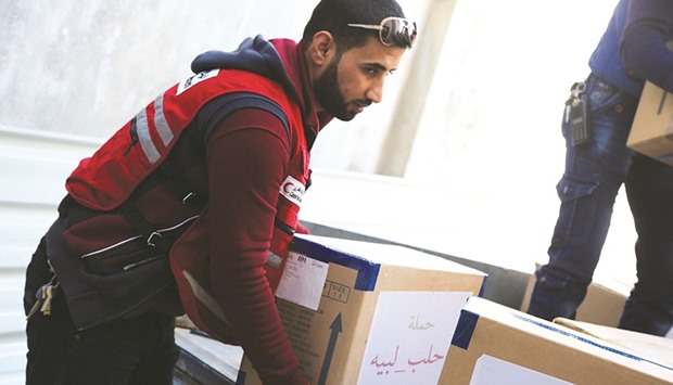 QRCS staff distributing medical aid for Aleppo health facilities.