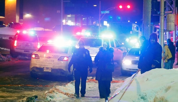 Police officers are seen near a mosque after a shooting in Quebec City.