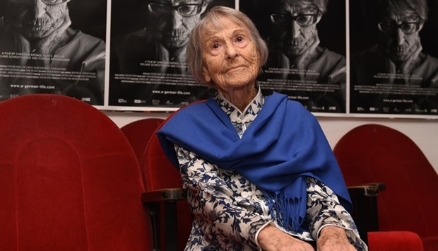 Brunhilde Pomsel, former secretary of Nazi propaganda chief Joseph Goebbels, sitting on a cinema chair in front of posters for the movie ,A German Life, in a cinema in Munich, southern Germany. File photo  taken on June 29, 2016