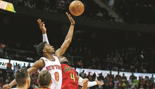New York Knicks guard Justin Holiday (No 8) hits the jump ball away from Atlanta Hawks forward Paul Millsap (No 4) during the fourth overtime at Philips Arena. PICTURE: USA TODAY Sports