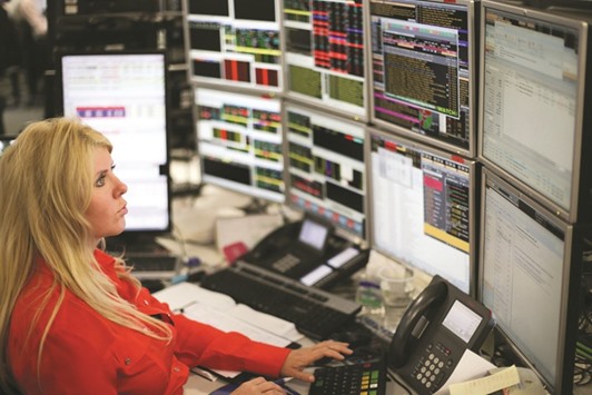 A trader monitors stock prices at the London Stock Exchange. The FTSE 100 yesterday lost 0.9% to 7,118.48 points after Donald Trumpu2019s controversial travel ban.