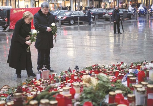 Merkel and Poroshenko lay down flowers yesterday at a memorial to commemorate the victims of the Berlin Christmas market attack, at Breitscheidplatz near the Kaiser-Wilhelm-Gedaechtniskirche (Kaiser Wilhelm Memorial Church) in Berlin. On December 19, 2016, suspected Islamist militant Anis Amri ploughed a hijacked truck into the market, killing 12 people, including the vehicleu2019s registered driver.