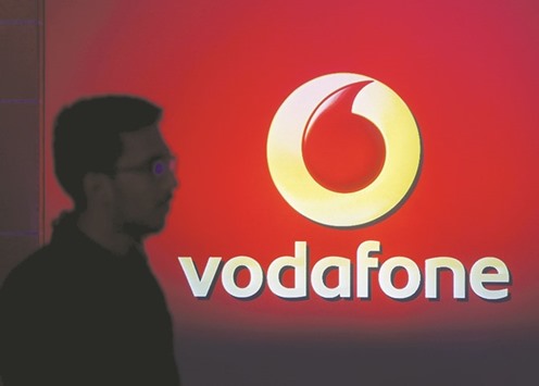 A man casts silhouette onto an electronic screen displaying the logo of Vodafone India after a news conference to announce the half year results in Mumbai. The worldu2019s second-largest cellphone operator has endured a tumultuous ride since it entered India in 2007, with fierce competition and a high-profile tax battle making a business contributing more than 10% of its revenues and profits its most unpredictable by far.