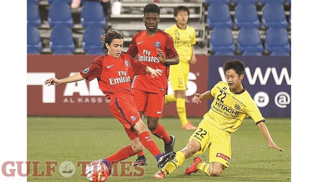 Kashiwa Reysolu2019s Kenta Tsutsumi (right) vies for the ball with a Paris Saint-Germain player during the Al Kass U-17 International Cup fifth place playoff at Aspire Zone yesterday.