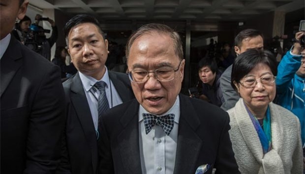 Hong Kong's former chief executive Donald Tsang leaves the High Court with his wife Selina Tsang during the first day of his corruption trial in Hong Kong on Tuesday.