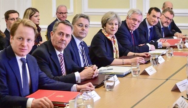 British Prime Minister Theresa May (C) sits with colleagues