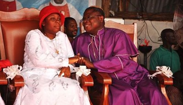 Vicentia Tadagbe Tchranvoukinni (L), the founder of the  coult with a priest.
