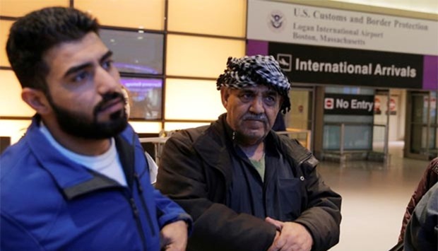 Mohanmmed (L) and his father Jasim, who arrived on a flight from Doha, talk to reporters after President Donald Trump's travel ban at Logan Airport in Boston.
