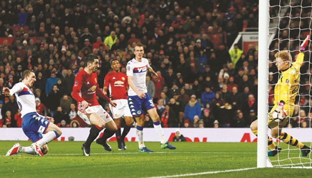 Manchester Unitedu2019s Henrikh Mkhitaryan (second from left) scores a goal against Wigan Athletic during their FA Cup fourth round match at Old Trafford on Sunday. (Reuters)
