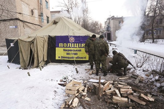 Ukrainian servicemen set up tents and make fires to warm local residents of town of Avdiivka.