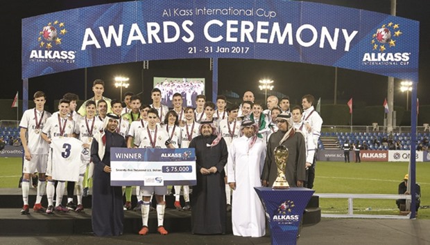 Real Madrid team celebrate with the trophy after winning the Al Kass International Cup at Aspire Zone yesterday. PICTURES: Jayaram