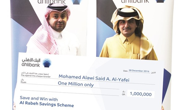 Mohamed Alawi Said A al-Yafei (right) receiving his prize from Hassan AlEfrangi.