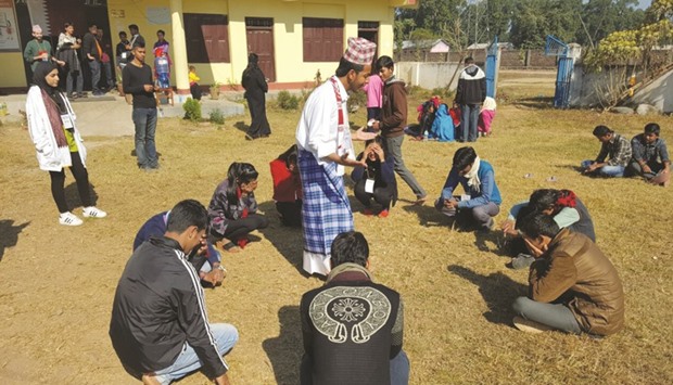 Rota-CNA-Q volunteers interact with Nepali youth during a workshop.