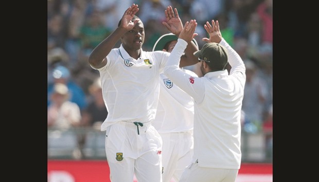 South African bowler Kagiso Rabada (L) celebrates the dismissal of Sri Lanka batsman Dinesh Chandimal (not in picture) at Newlands Cricket Stadium in Cape Town yesterday.