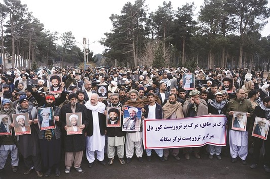 Afghan Shias hold posters and chant slogans during a demonstration in Herat yesterday.