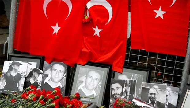 Flowers and pictures of victims are placed near the entrance of Reina nightclub, which was attacked by a gunman in Istanbul.