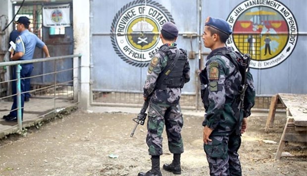 Armed police stand guard at the gates of the district jail, from where more than a hundred inmates escaped, in the town of Kidapawan, in southern island of Mindanao on Wednesday.