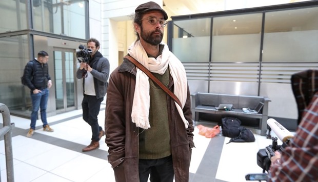 French farmer Cedric Herrou (C) speaks to journalists as he arrives at the courthouse of Nice, southeastern France.