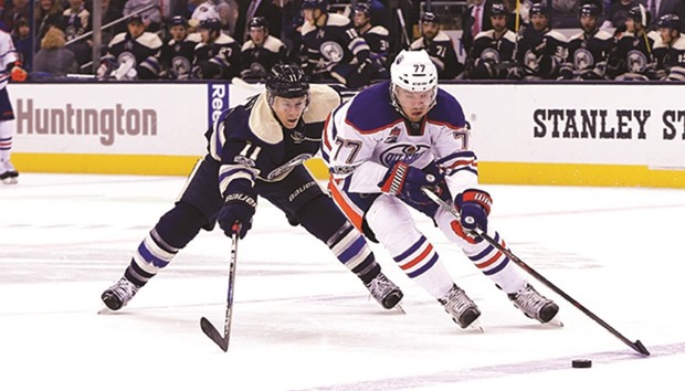 Columbus Blue Jackets left wing Matt Calvert (11) tries for the stick check against Edmonton Oilers defenseman Oscar Klefbom (77) during the third period of their NHL game yesterday. Columbus won 3-1. (Russell LaBounty-USA TODAY Sports)