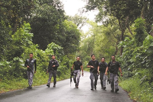 Prison personnel patrol during a manhunt for more than 150 inmates who escaped after gunmen stormed a prison in North Cotabato province, southern Philippines yesterday.