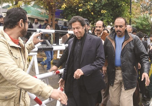 Pakistani opposition leader Imran Khan walks with officials as he leaves the Supreme Court in Islamabad yesterday, after a case hearing over the Panama Papers. Pakistan Premier Nawaz Sharif has been under growing pressure from opposition parties, mainly Imran Khanu2019s Pakistan Tehreek-i-Insaf (PTI) over alleged corruption charges against the prime ministeru2019s family. Khan alleged that the prime minister had lied in the Supreme Court and the Parliament which is tantamount to perjury.