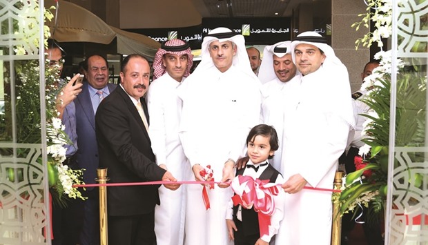 Sheikh Dr Khaled formally inaugurates QIIBu2019s Al Sadd branch in the presence of al-Shaibei (right) among other dignitaries.