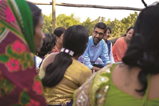 Google Inc CEO Sundar Pichai (C) talks to a group of woman known as u2018Internet Sathisu2019 who learn mobile Internet from Google and then teach other villagers, in Gokulpur village some 140km west of Kolkata yesterday.