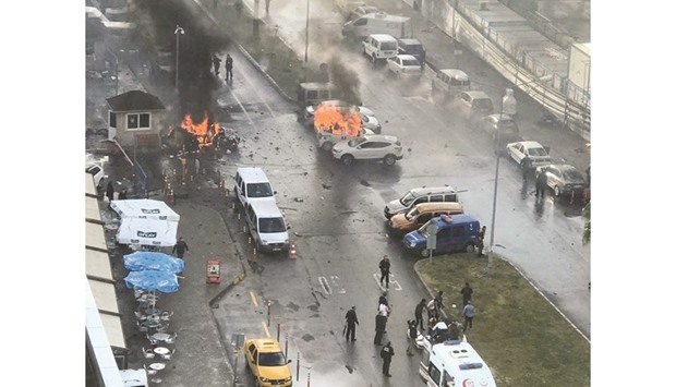 Burning cars are seen after the explosion outside a courthouse in Izmir.