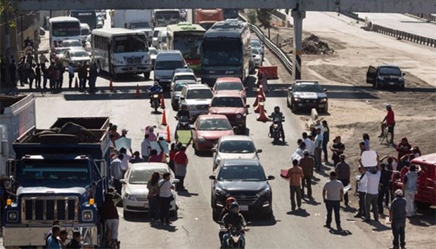 People block a highway in Mexico City following protests over an increase in gas prices.