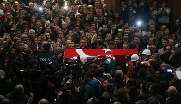 A coffin is carried during the funeral ceremony of Turkish police officer Fethi Sekin and courthouse officer Musa Can, who were killed in a car bombing on January 5, at the courthouse of Izmir on Friday.