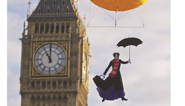 An image depicting the film character u201cMary Poppinsu201d wearing a pollution mask is floated in the air near Big Ben in London yesterday during a photocall by Greenpeace to highlight the levels of air pollution in the capital.