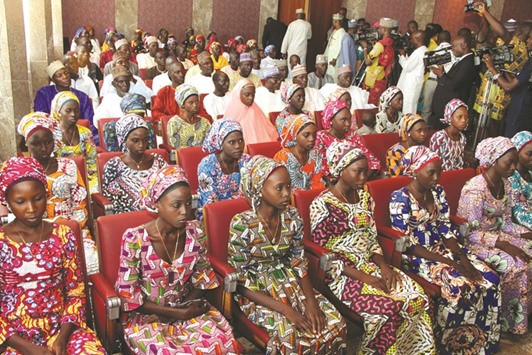 This file photo taken on October 19, 2016 shows the 21 Chibok girls who were released by Boko Haram, attending an function at the presidential State House in Abuja.