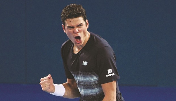 Milos Raonic reacts after his win over Rafael Nadal (above) yesterday. (AFP)