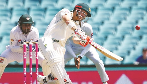 Australiau2019s David Warner hits a six on Day Four of the third Test against Pakistan in Sydney yesterday. (Reuters)