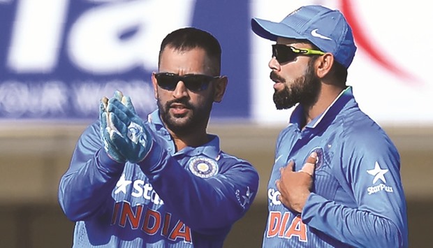Two days after Mahendra Singh Dhoni (left) stood down as captain of both the Twenty20 and 50 overs sides, Virat Kohli (right) was confirmed as skipper in all three format of the game. (AFP)