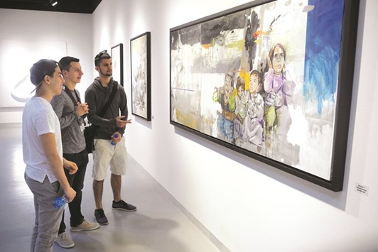 Visiting students view one of the works of Qatari artist Jameela al-Ansari at Katara u2013 the Cultural Village. PICTURE: Peter Alagos