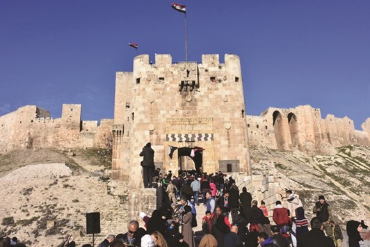 People gather at the Citadel of Aleppo yesterday. Moscowu2019s intervention in September 2015 helped turn the tide in favour of President Bashar al-Assad, whose forces scored a major victory last month with the recapture of opposition stronghold east Aleppo.